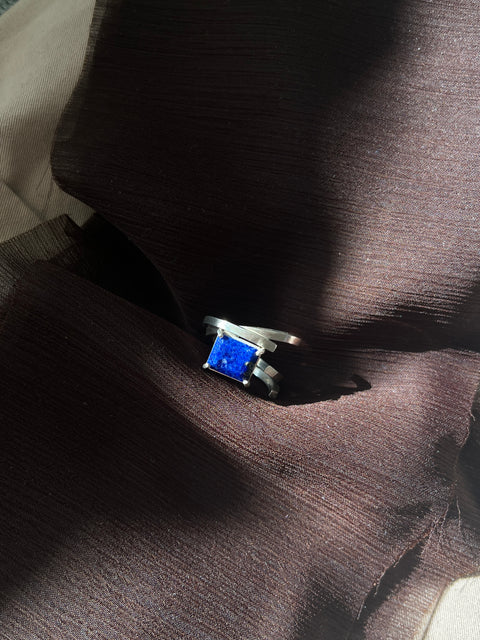 Ring with a blue stone on a brown fabric background