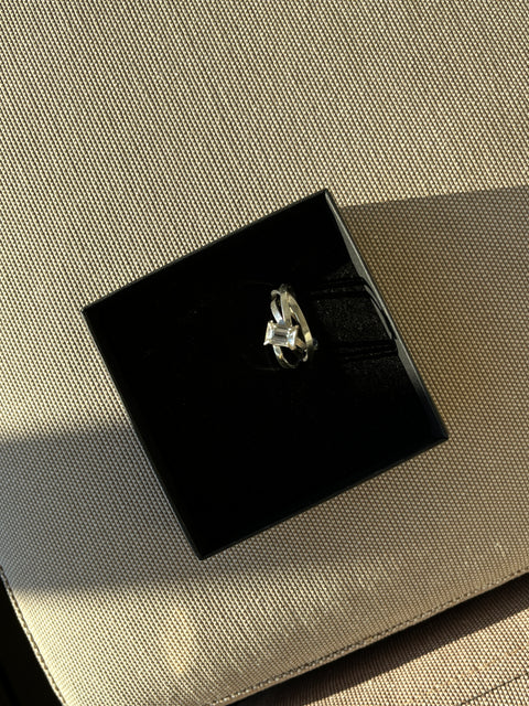 silver ring with gemstone in a box