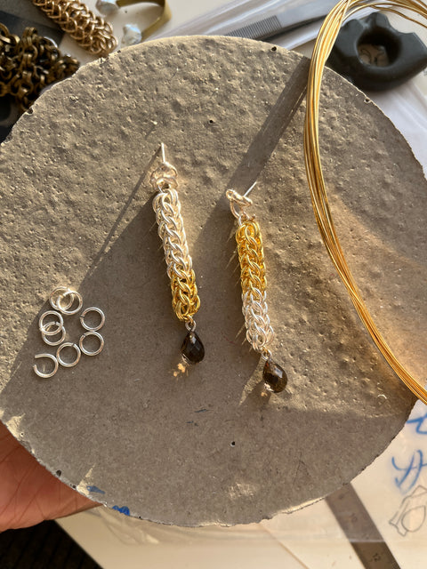Gold and silver chain jewelry on a stone surface